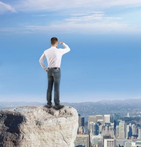 Business looking over city from ledge